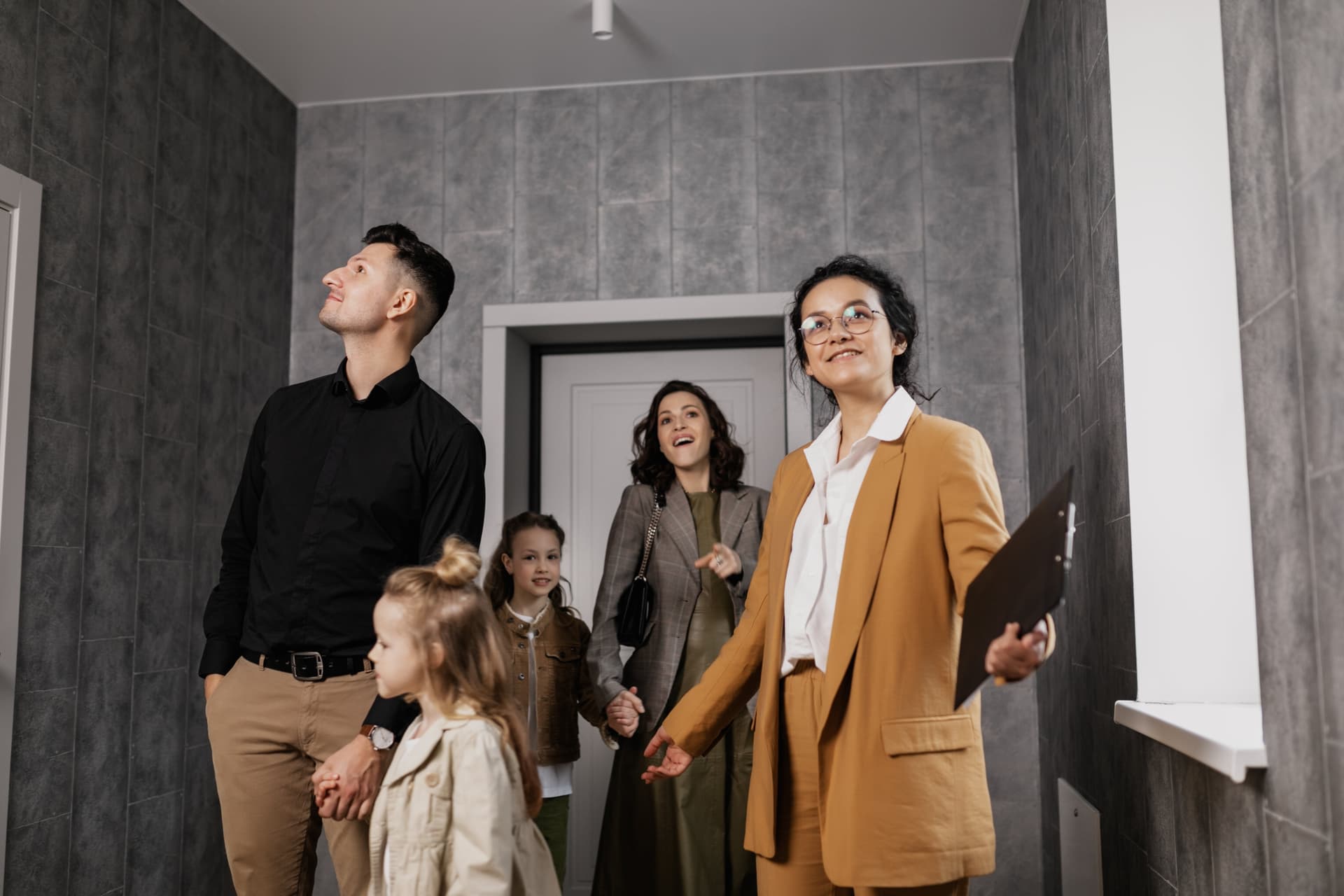 Professional property manager showing a home to a family